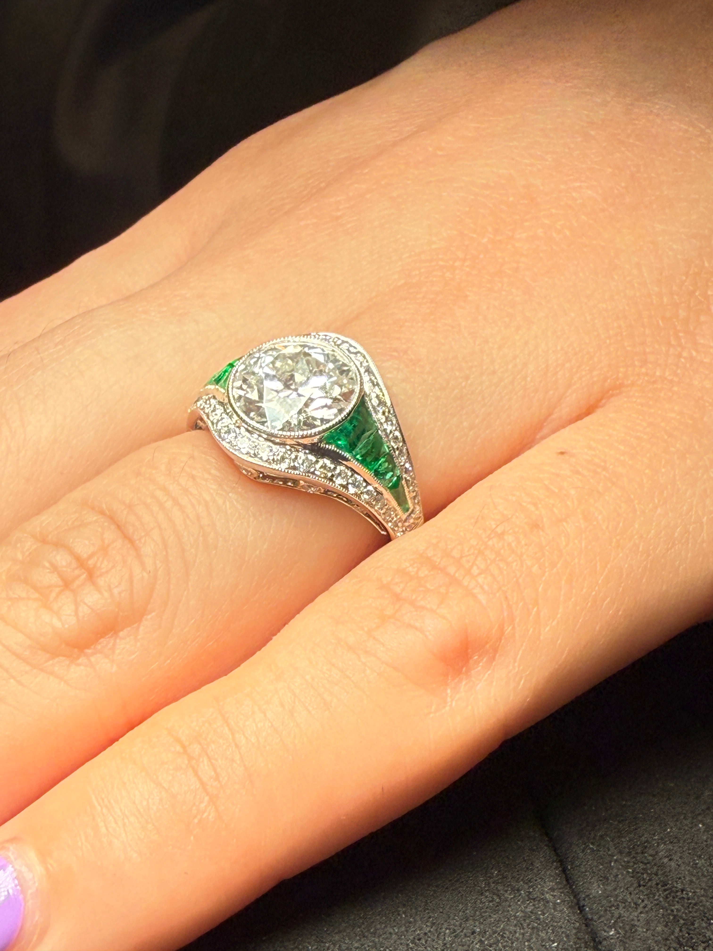 Diamond and emerald engagement ring