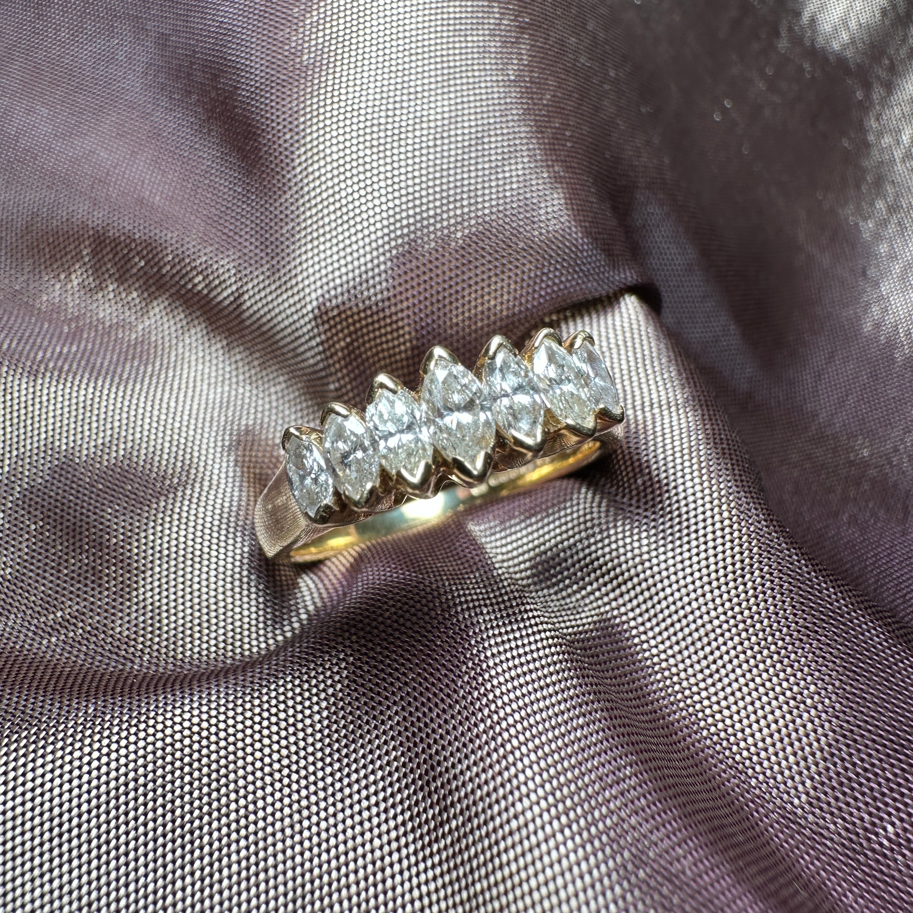 18-carat gold ring featuring seven marquise-cut diamonds