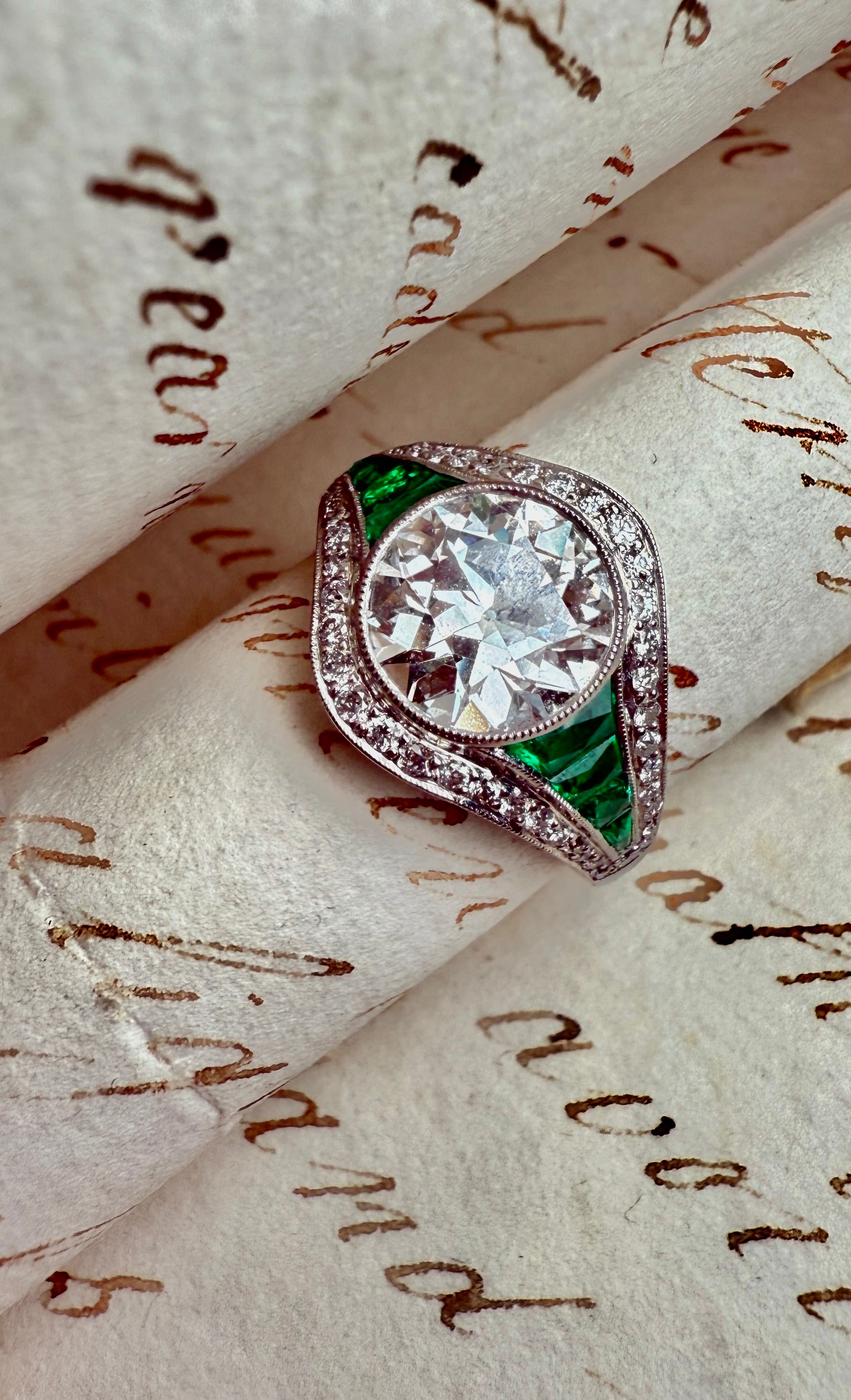 Diamond and emerald engagement ring