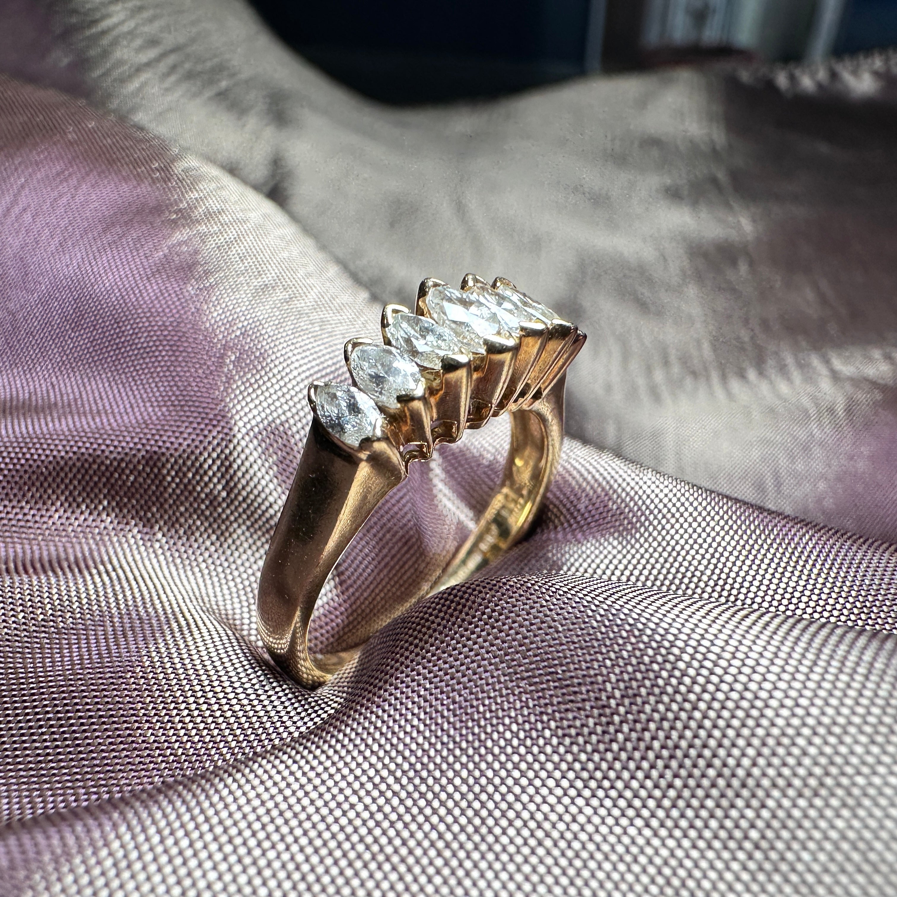 18-carat gold ring featuring seven marquise-cut diamonds