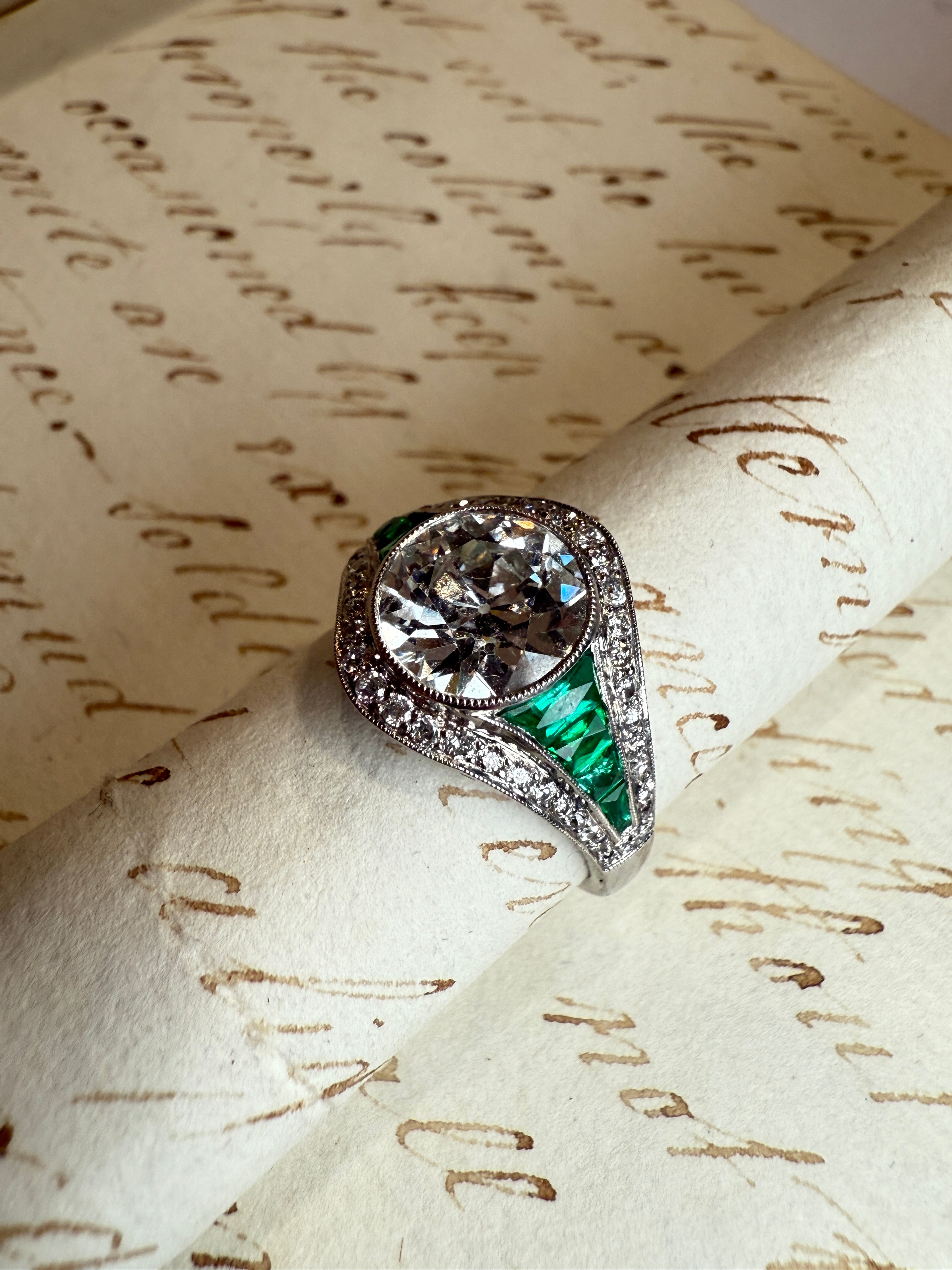 Diamond and emerald engagement ring
