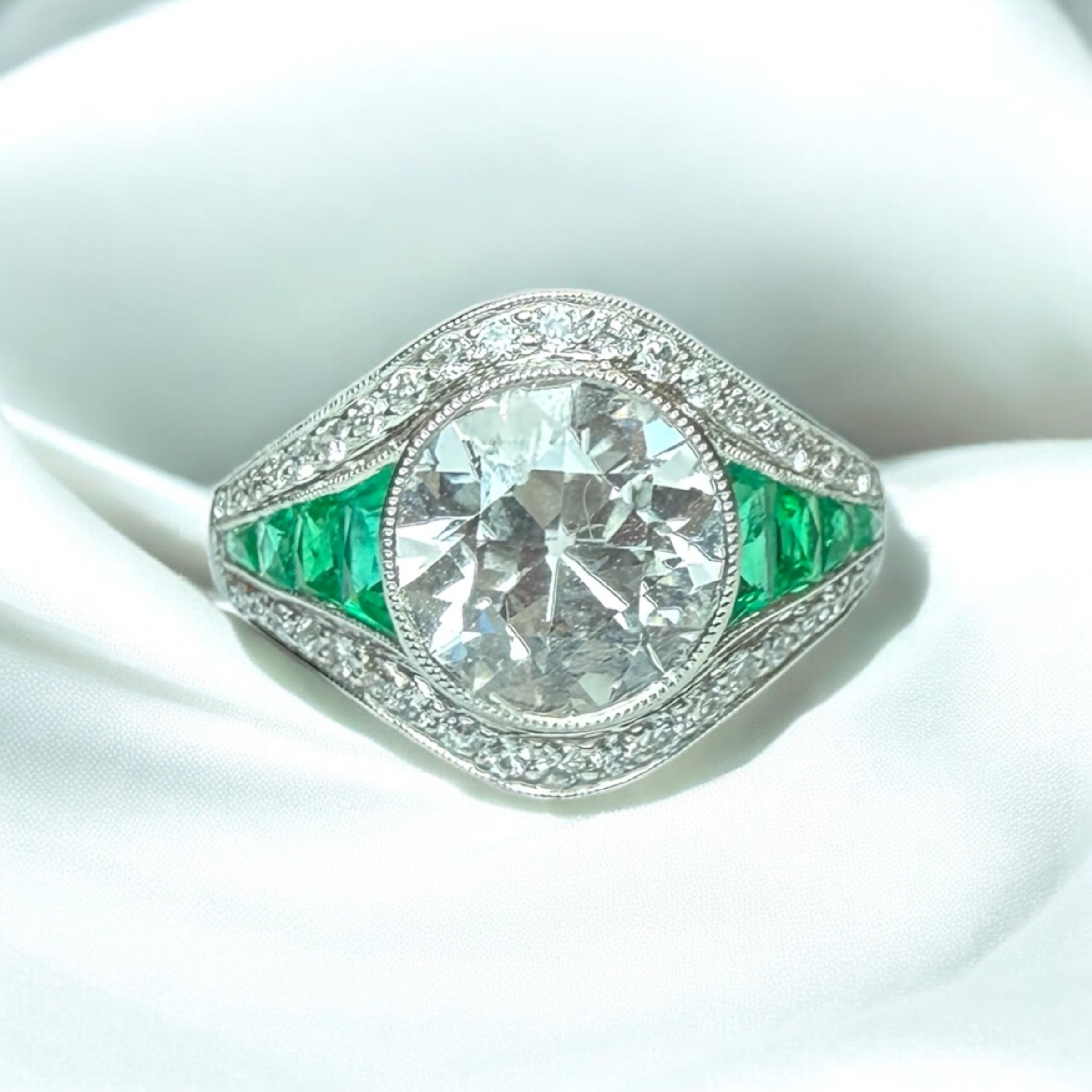 Diamond and emerald engagement ring