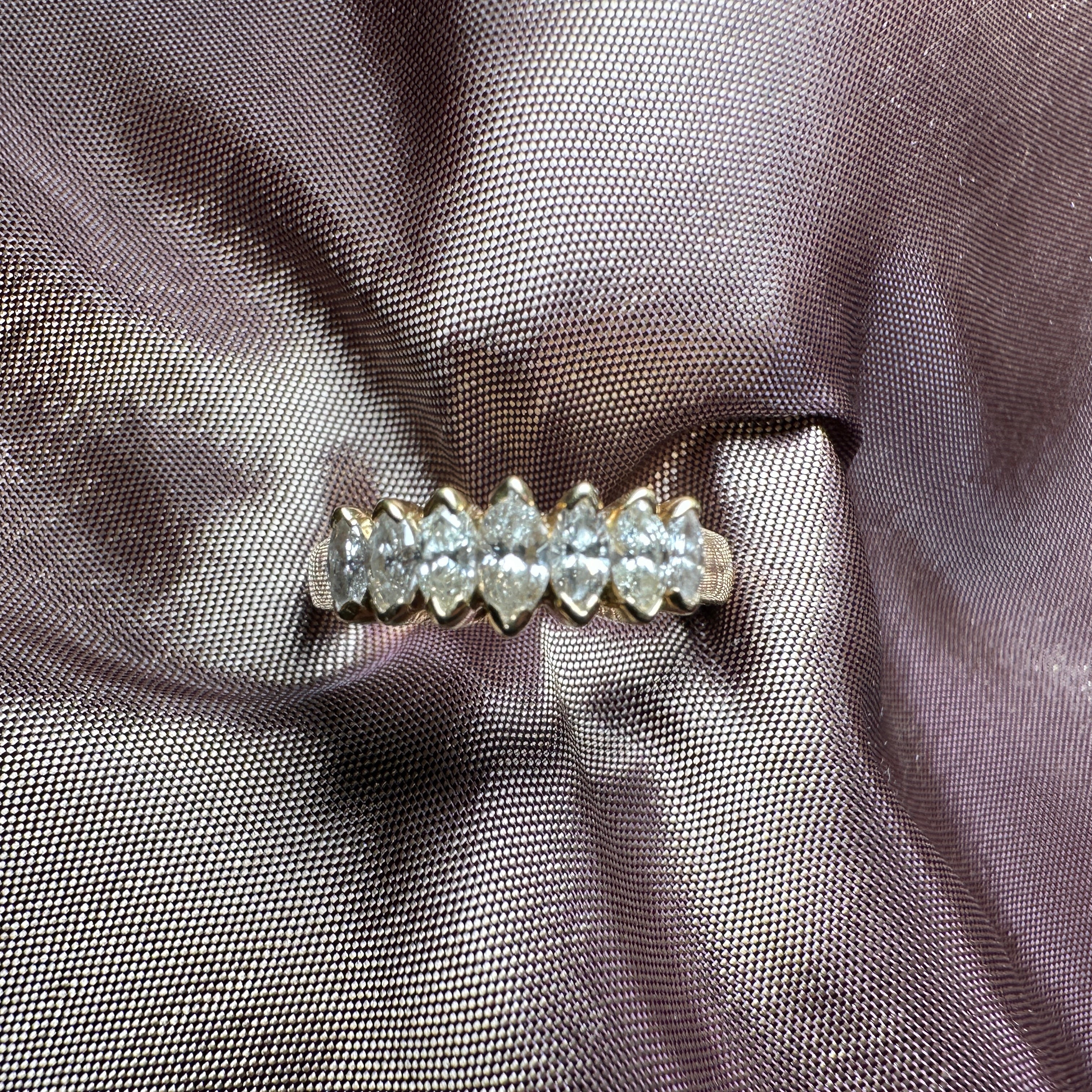 18-carat gold ring featuring seven marquise-cut diamonds