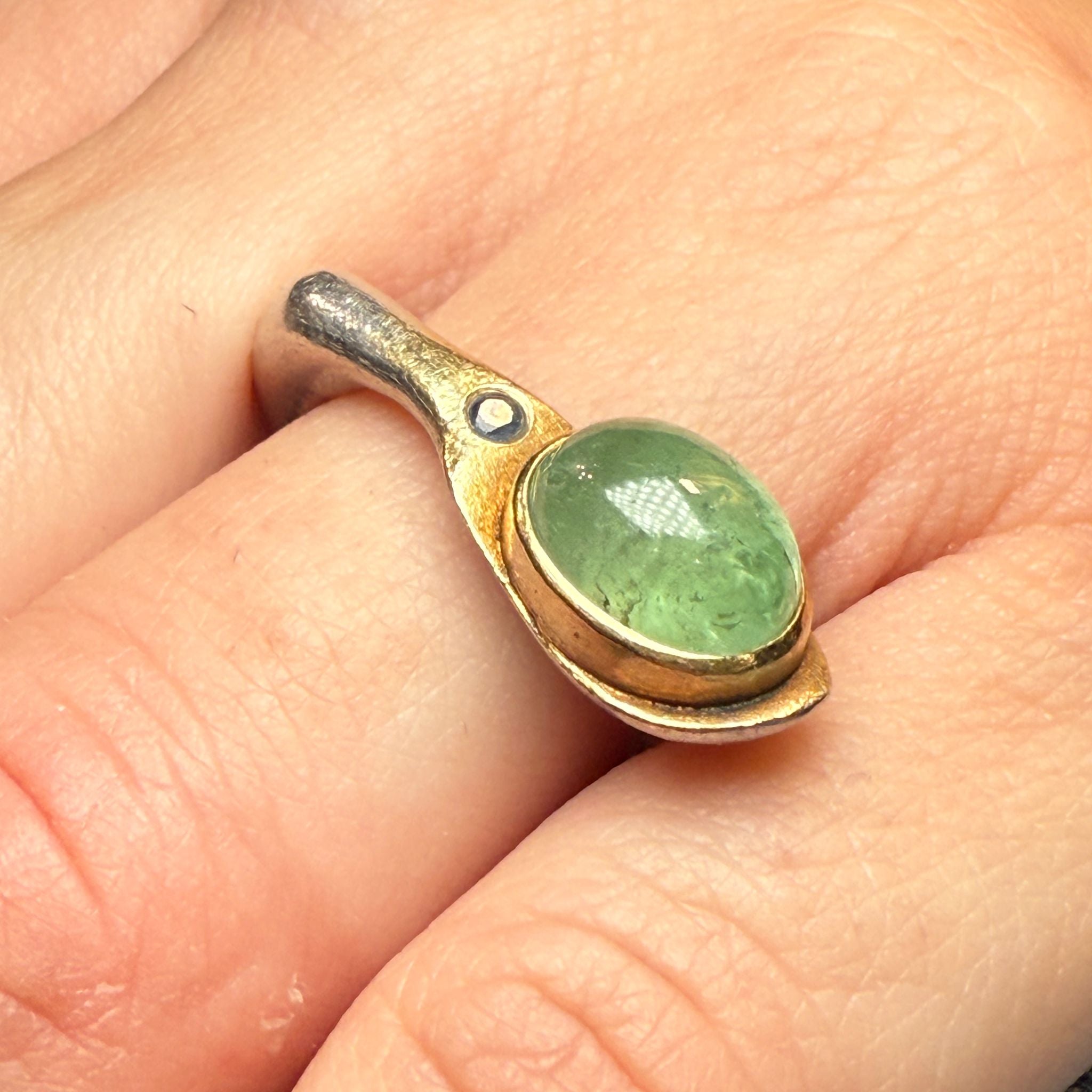 Silver and gold ring with green stone